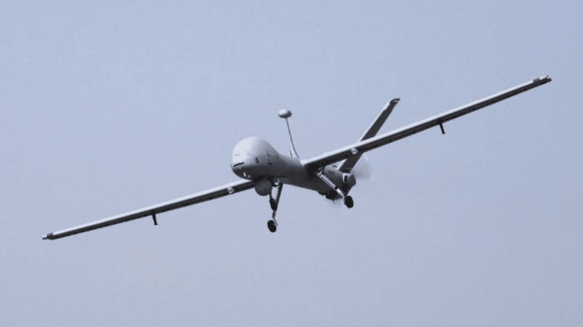 A winged drone flies through the sky